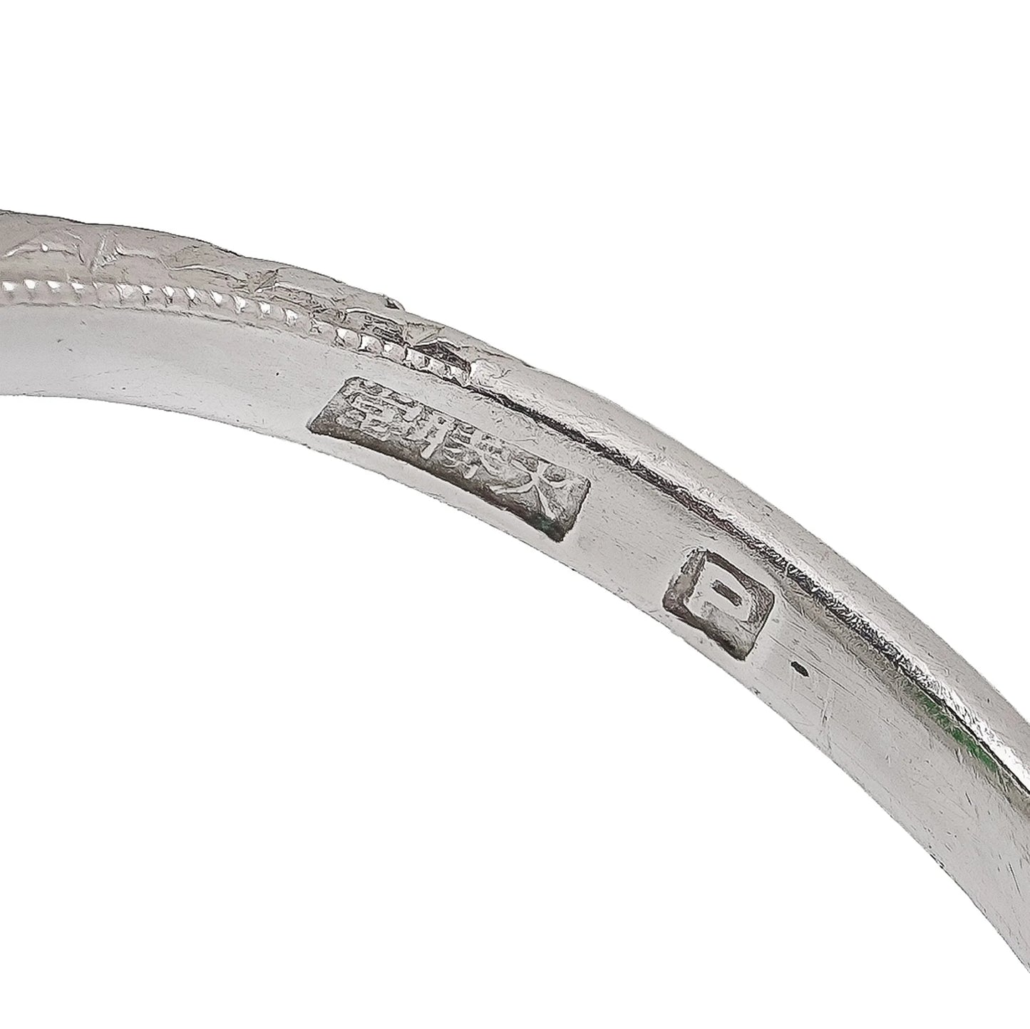 Close-up of a Chinese stamp inside a platinum ring shank