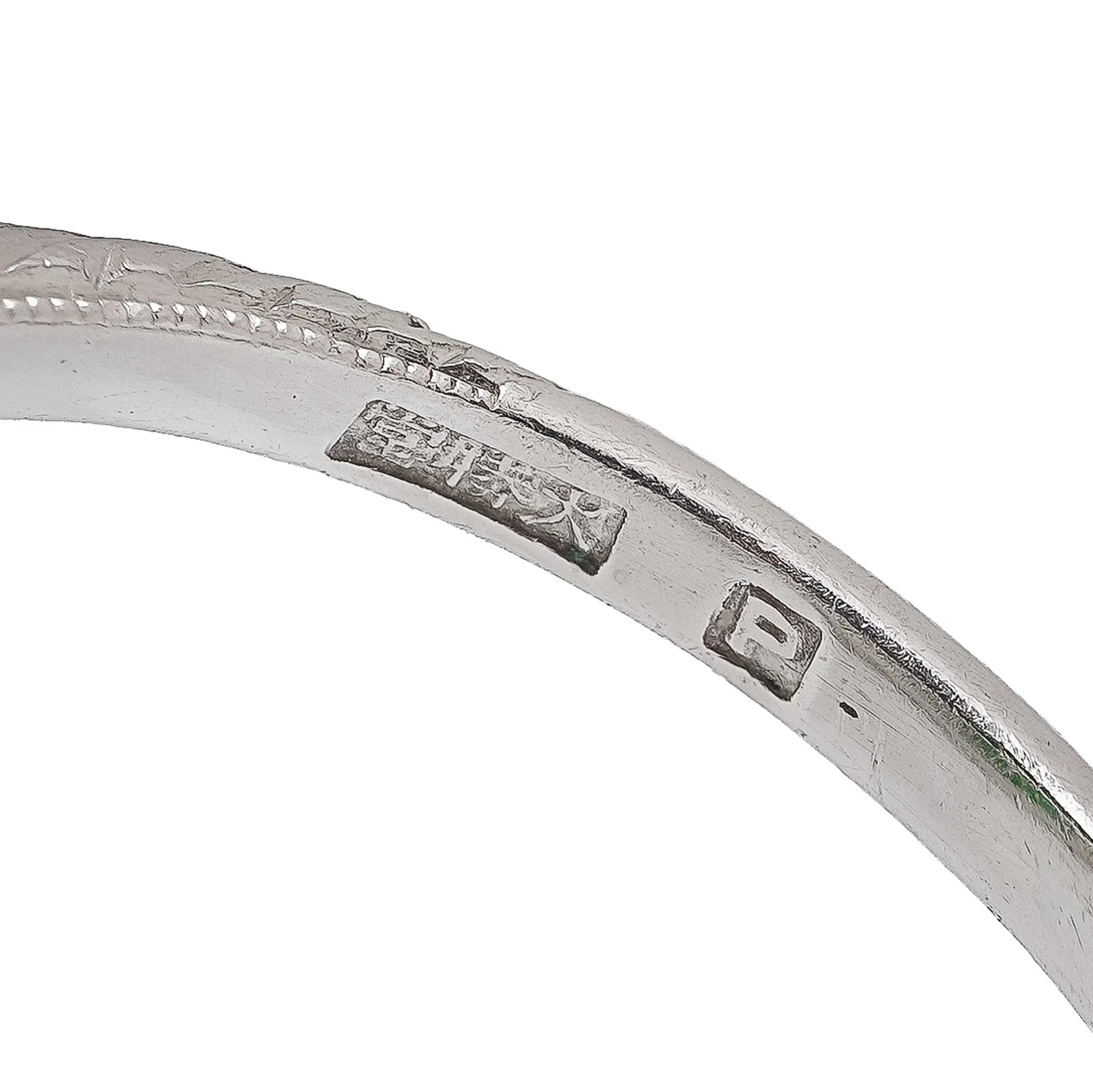 Close-up of a Chinese stamp inside a platinum ring shank
