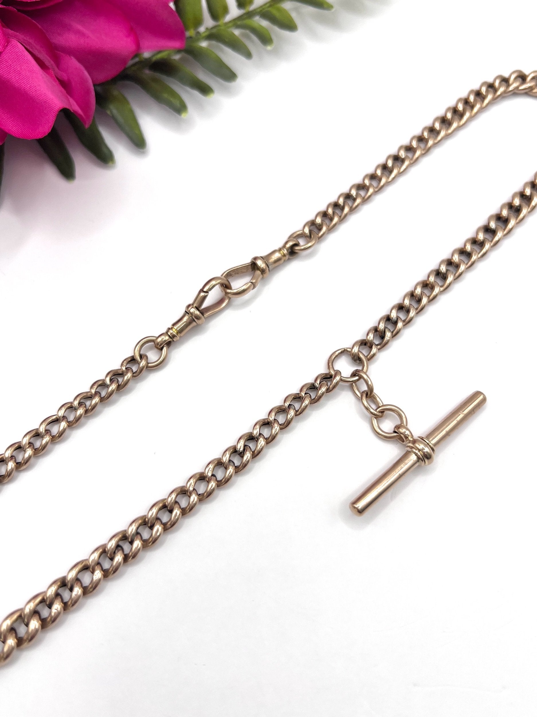 A rose gold curb link Albert chain with t-bar