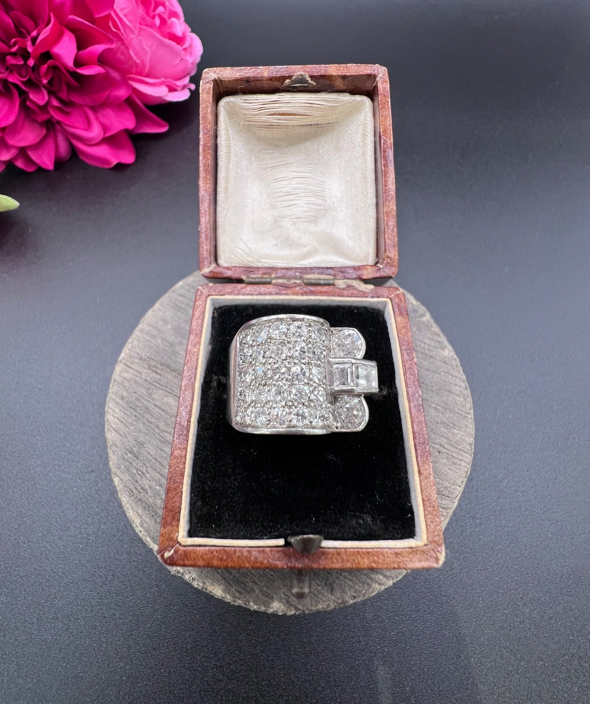 A round diamond tank style cocktail ring in platinum, in a ring box