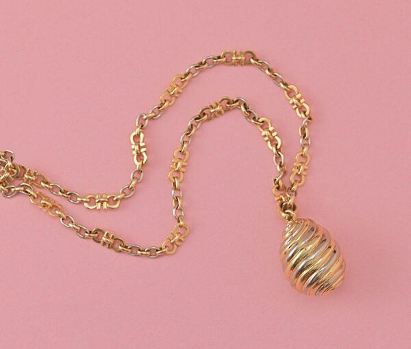 Cartier Tri Colour Gold Fancy Link Chain with Pendant; links comprising of two Cartier C’s, alternated with oval white, rosé and yellow gold links, rosé gold lock. Signed and numbered