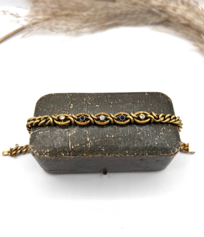 A sapphire and diamond fancy curb link bracelet in yellow gold