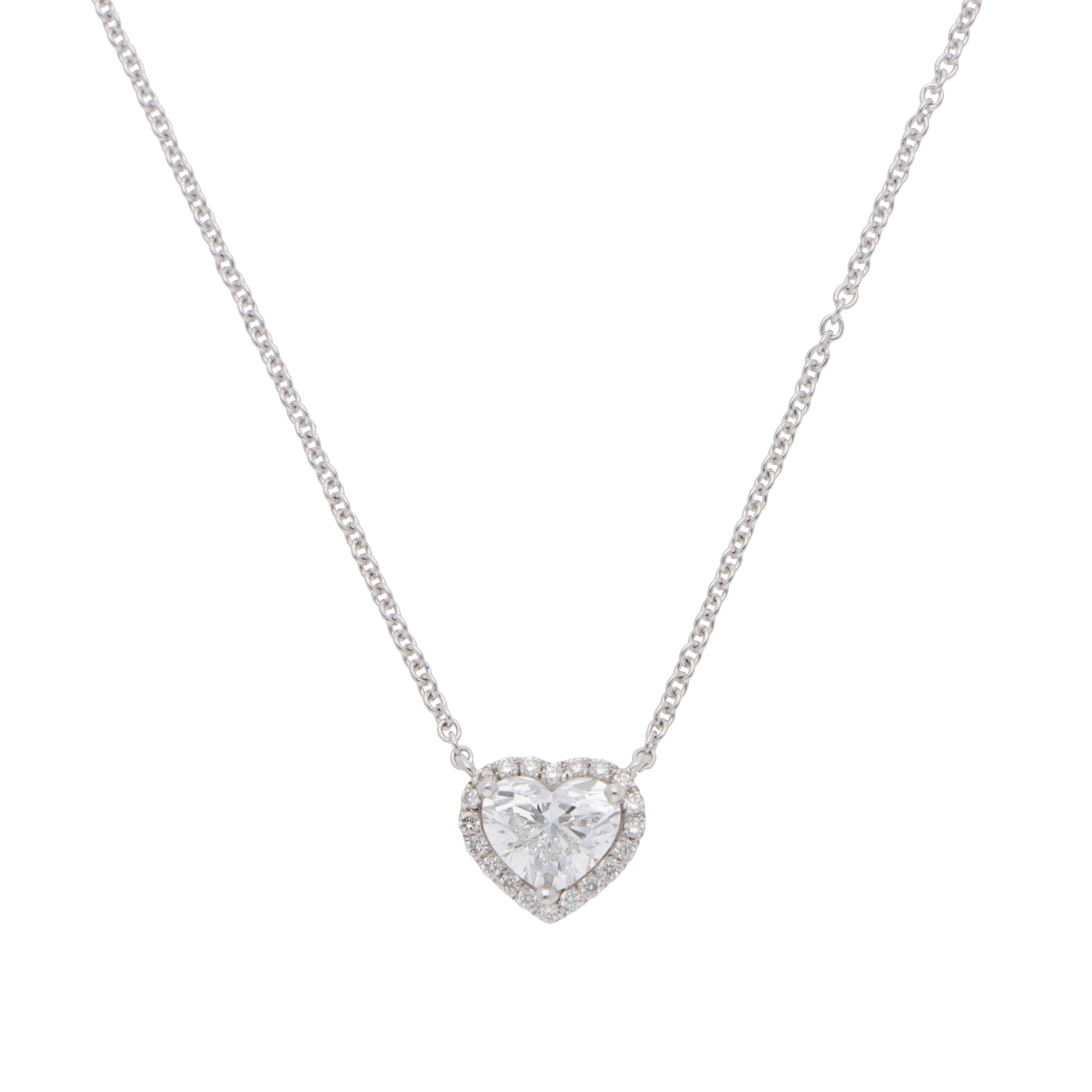 A heart shaped diamond cluster pendant on a white gold chain, on a white background