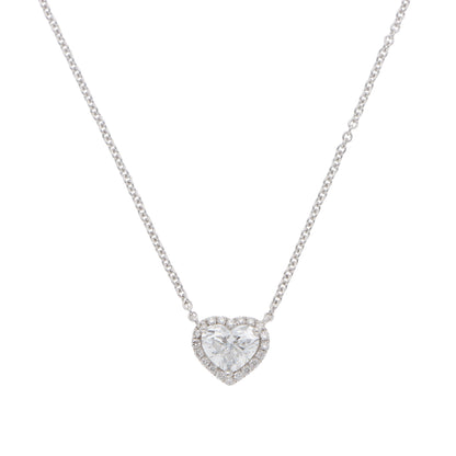A heart shaped diamond cluster pendant on a white gold chain, on a white background