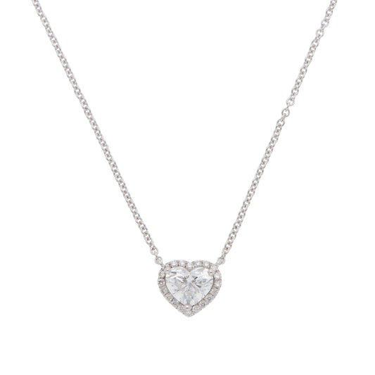 A heart shaped diamond cluster pendant on a white gold chain, on a white background
