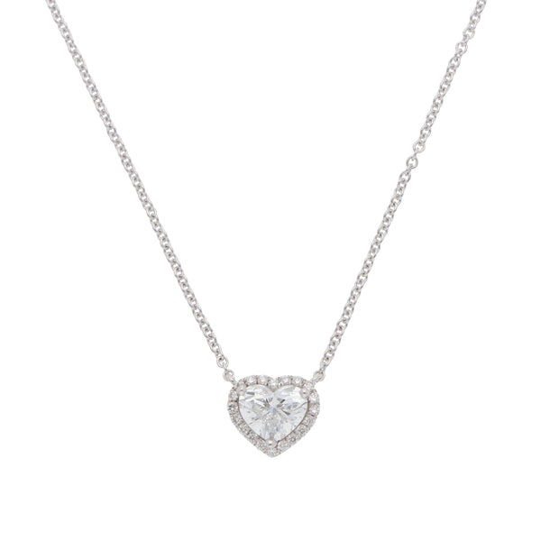 A heart shaped diamond cluster pendant on a white gold chain, on a white background