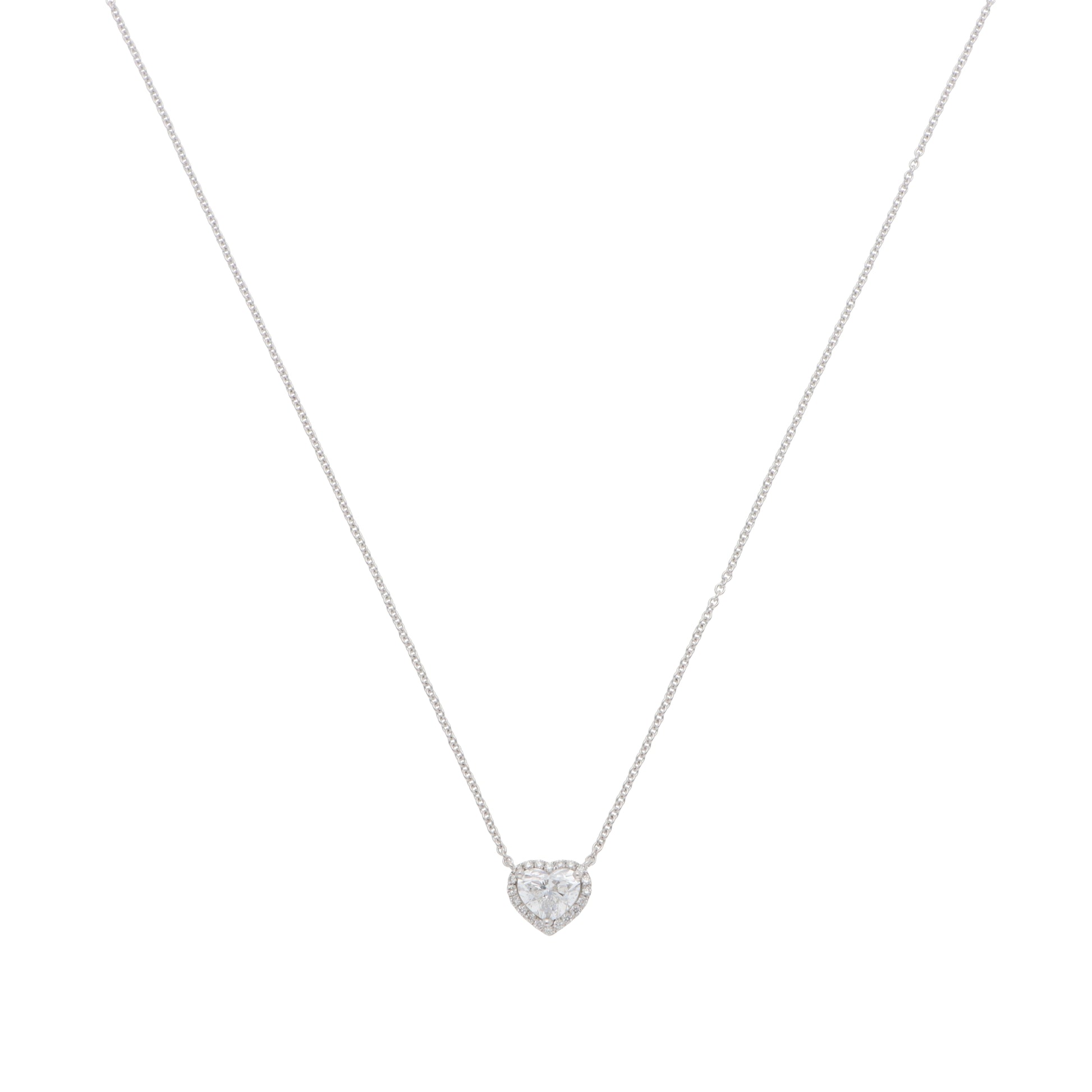 A heart shaped diamond cluster pendant on a white gold chain, on a white background