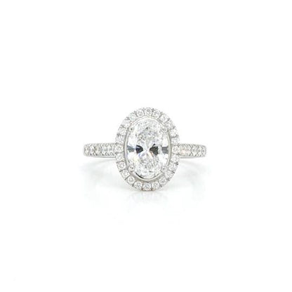 Oval Diamond Cluster Ring; an oval-cut 1.50ct diamond surrounded by diamonds, accented with diamond set shoulders,set in platinum, with GIA certificate.