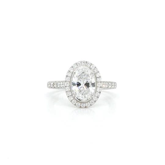 Oval Diamond Cluster Ring; an oval-cut 1.50ct diamond surrounded by diamonds, accented with diamond set shoulders,set in platinum, with GIA certificate.