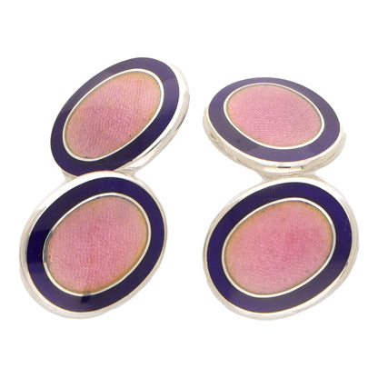 Pair of pink and navy oval silver cufflinks on a white background