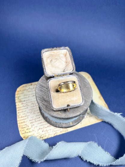A yellow gold triple row ring with garnets and seed pearls, in a box
