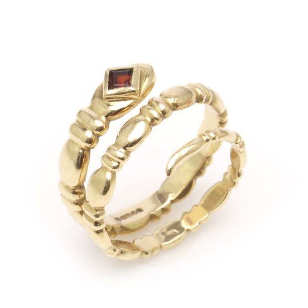 Vintage 18ct Yellow Gold Snake Ring with Garnet; in the form of a snake's body entangling around the wearer's finger, with a square cut garnet to the head, Circa 1989