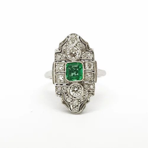 Art Deco Emerald and Diamond Cluster Plaque Ring; central emerald flanked top and bottom by a diamond, surrounded by smaller diamonds, in 18ct white gold