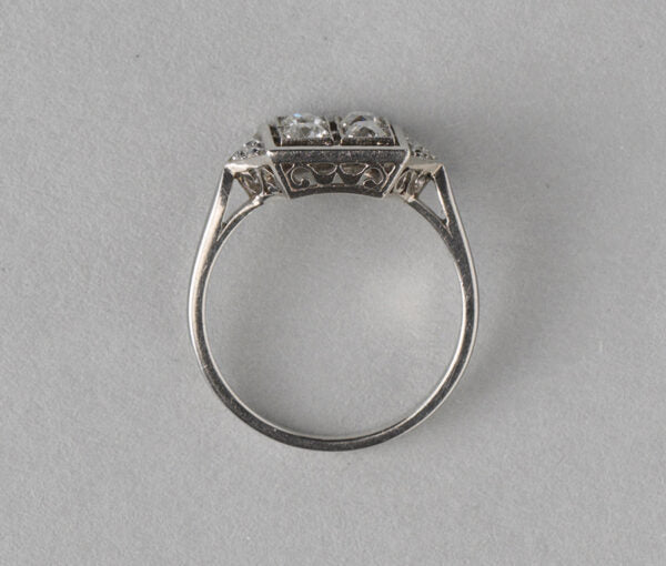 Art Deco French 0.70ct Old Cut Diamond and Platinum Square Ring; four old cut diamonds, flanked by diamond-set triangle shoulders, Numbered, Circa 1920