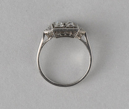 Art Deco French 0.70ct Old Cut Diamond and Platinum Square Ring; four old cut diamonds, flanked by diamond-set triangle shoulders, Numbered, Circa 1920