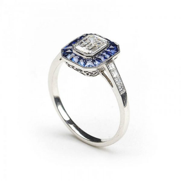 0.69ct Emerald Cut Diamond and Sapphire Cluster Ring, E VS2, Square-cut diamond set shoulders, mounted in platinum