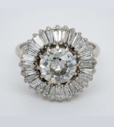 Old Cut Diamond Ballerina Cluster Ring; central 1.80 carat old European-cut diamond surrounded by 1.50 carats of tapering baguette-cut diamonds