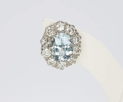 Aquamarine and Diamond Oval Cluster Earrings; 2.50cts oval aquamarines surrounded by 1.90cts round brilliant-cut diamonds, in 18ct white gold