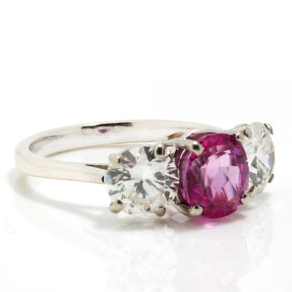 Natural Pink Sapphire and Diamond Three Stone Ring; central 1.50ct natural pink sapphire flanked by 2cts round brilliant-cut diamonds, all claw set in platinum