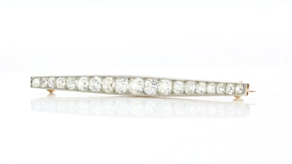 Art Deco Old Cut Diamond Bar Brooch; set with 1.20 carats of graduating old-cut diamonds. Mounted in platinum and backed with 18ct yellow gold. Circa 1920s