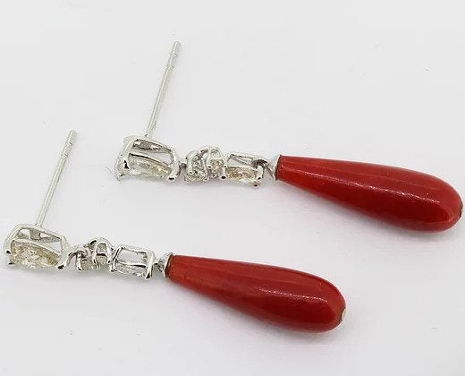 Coral and Diamond Drop Earrings; each featuring a coral drop suspended by three graduated diamonds, claw set in 18ct white gold