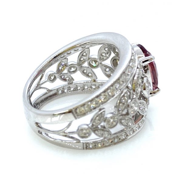 3.19ct Padparadscha Sapphire and Diamond Dress Ring by David Jerome; the central, unheated 3.19 carat oval faceted padparadscha sapphire is nestled upon a wide floral openwork band set with 1.56 carats of sparkling white diamonds, in 18ct white gold