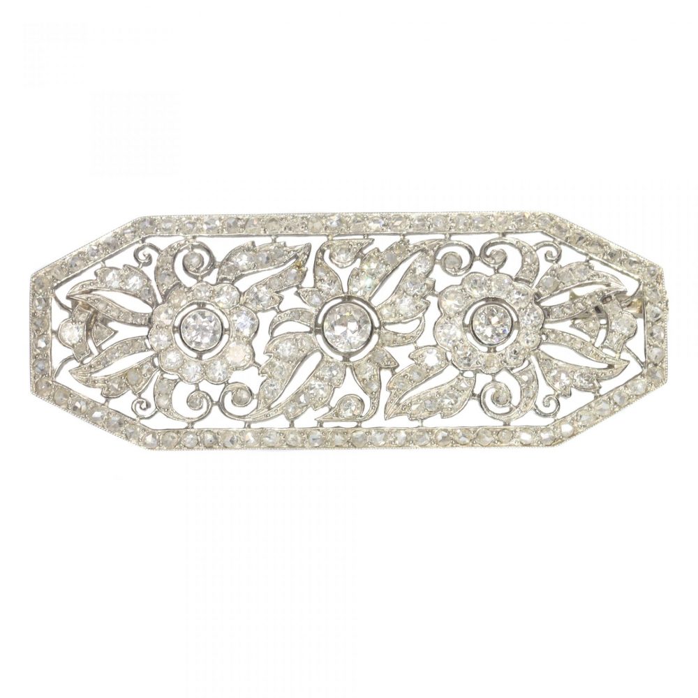 Art Deco French 1.40ct Diamond Brooch in Platinum; openwork floral design design set with over 1.40 carats of old-cut, single-cut and rose-cut diamonds. Mounted in platinum and 18ct white gold. Circa 1920