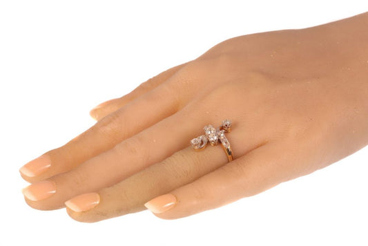 Belle Epoque Old Cut Diamond Crossover Ring, set with 1.04cts old cut diamonds accented with rose cut diamonds, in platinum and 18ct yellow gold, Circa 1910