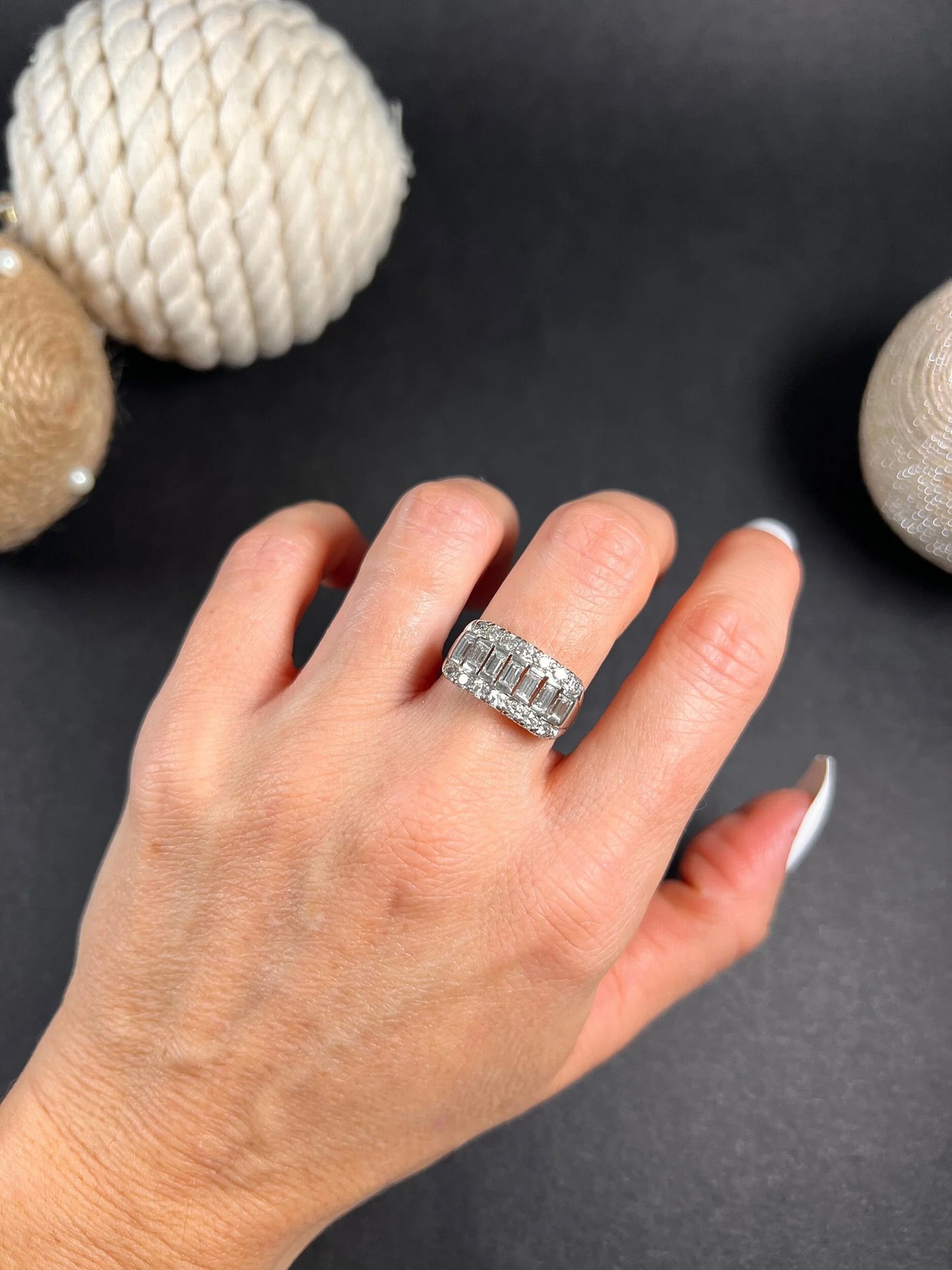 A three row diamond band ring in platinum modelled on a hand