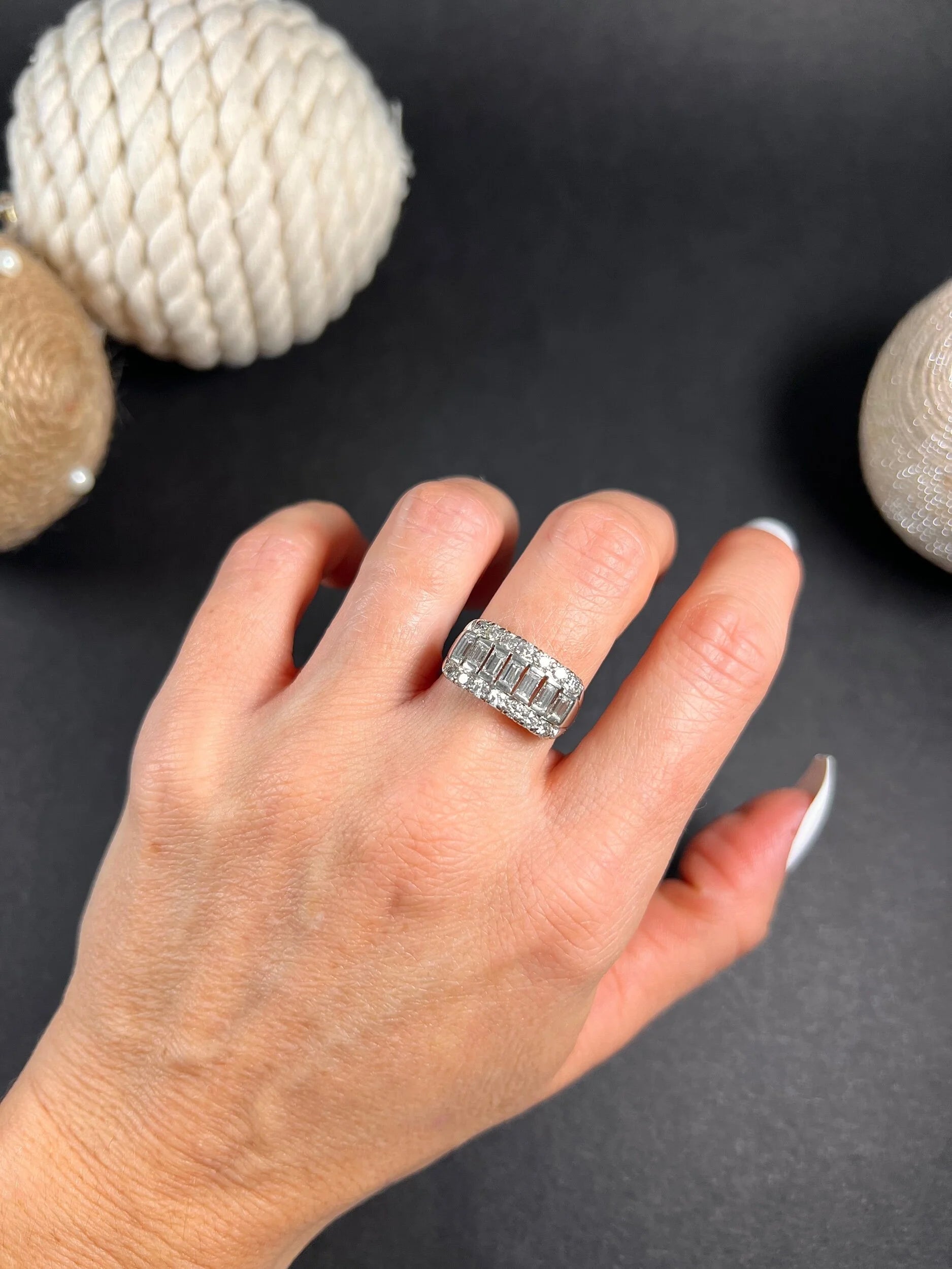 A three row diamond band ring in platinum modelled on a hand