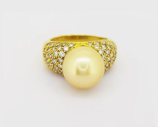 Vintage 11mm Golden South Sea Pearl and Diamond Bombe Dress Ring; A striking golden South Sea pearl and diamond enctrusted ring in 18ct yellow gold.
