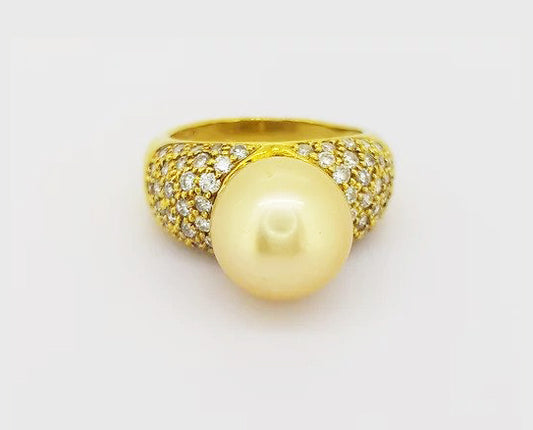 Vintage 11mm Golden South Sea Pearl and Diamond Bombe Dress Ring; A striking golden South Sea pearl and diamond enctrusted ring in 18ct yellow gold.