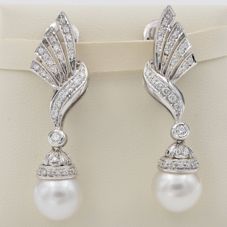 Glamorous Vintage Pearl and Diamond Spray Drop Earrings, diamond-set bow and spray designs suspending pearl drops in 18ct white gold. Circa 1960s