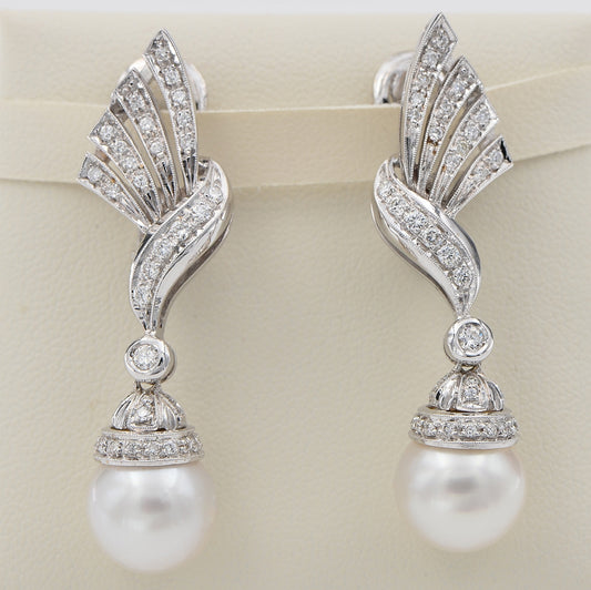 Glamorous Vintage Pearl and Diamond Spray Drop Earrings, diamond-set bow and spray designs suspending pearl drops in 18ct white gold. Circa 1960s