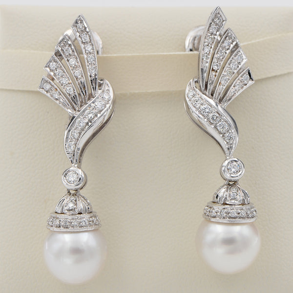 Glamorous Vintage Pearl and Diamond Spray Drop Earrings, diamond-set bow and spray designs suspending pearl drops in 18ct white gold. Circa 1960s