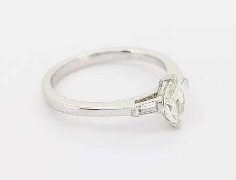 Marquise Cut Diamond Engagement Ring; set with a 0.45ct marquise-cut diamond flanked by 0.13ct baguette-cut diamond set shoulders, 18ct white gold.