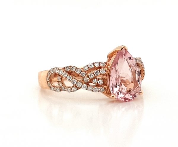 Pear Cut Morganite and Diamond Cluster Dress Ring; central 1.75 carat pear-shaped morganite flanked by 0.33cts diamond set overlapping waves and swirls, in 18ct rose gold