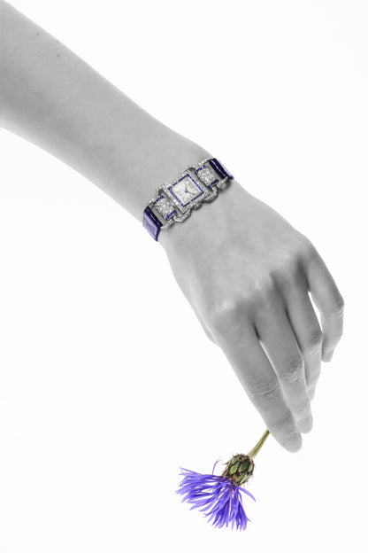 A ladies Art Deco design cocktail wristwatch set with diamonds and sapphires, on a blue leather strap, modelled on a wrist