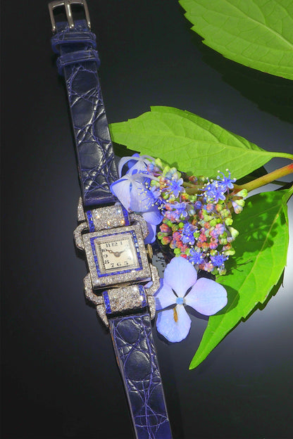 A ladies Art Deco design cocktail wristwatch set with diamonds and sapphires, on a blue leather strap, with flowers