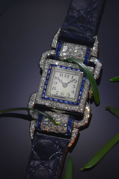 A ladies Art Deco design cocktail wristwatch set with diamonds and sapphires, on a blue leather strap