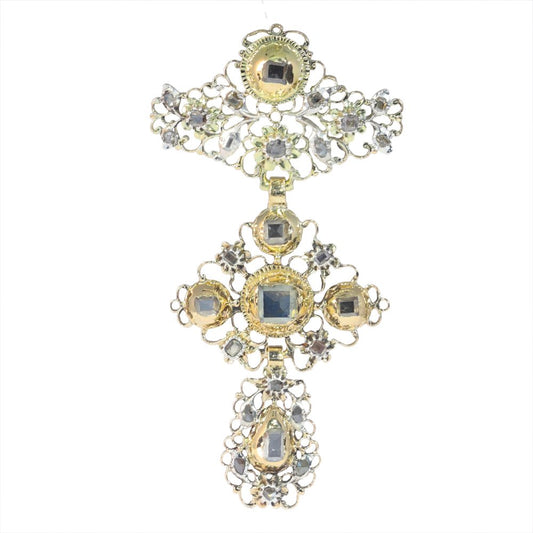 An ornate cross pendant in gold and silver with antique cut diamonds