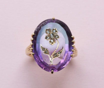 Antique Edwardian Oval Amethyst and Rose Cut Diamond Flower Ring; large oval facetted amethyst encrusted with rose cut diamonds, 18ct yellow gold