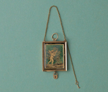 Early 19th Century 18ct Gold Angel Locket; black and gold ‘verre eglomisé’ angel picking roses, miniature key and lock, French gold mark for 1809-1819