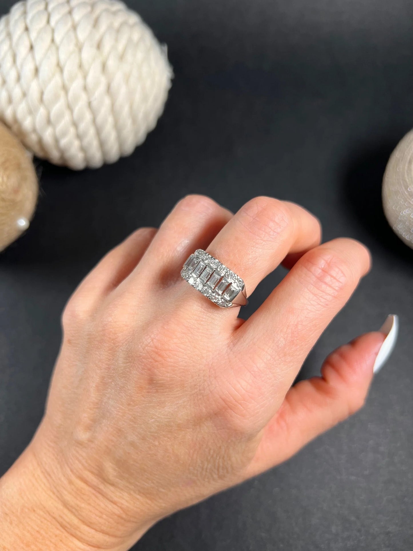 A three row diamond band ring in platinum modelled on a hand