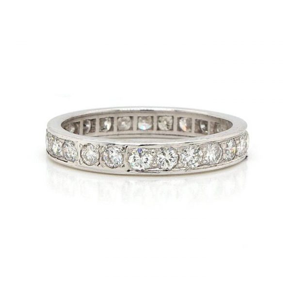 1.30ct Diamond Full Eternity Ring; A platinum full eternity ring channel-set with round brilliant cut diamonds totalling 1.30 carats. Finger size: N