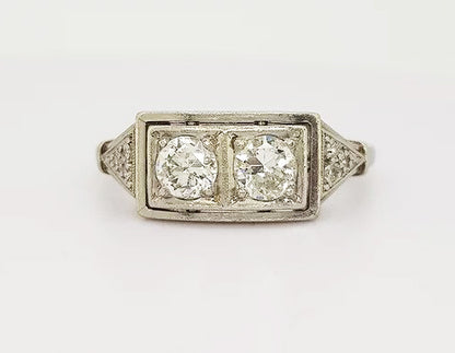 Art Deco Diamond Plaque Ring; This striking ring features two brilliant cut diamonds, claw set, and mounted in platinum. A classic geometric design.