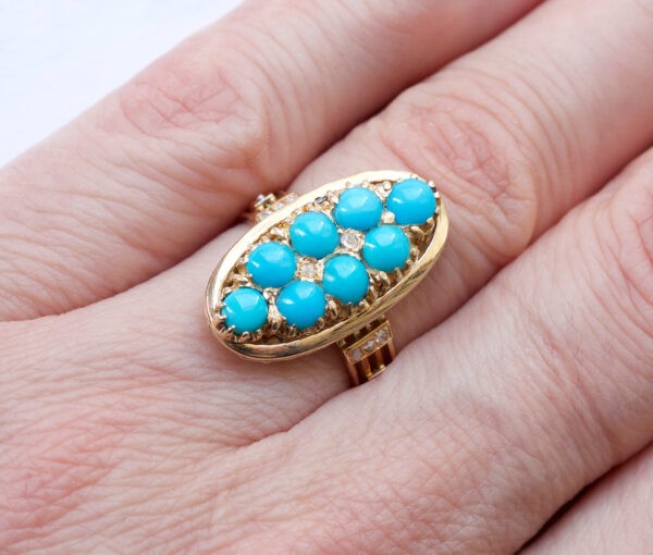 Antique Victorian Cabochon Turquoise, Diamond and Gold Oval Plaque Ring; 18ct yellow gold oval ring set with eight cabochon cut turquoises accented with nine rose cut diamonds. France, 19th century