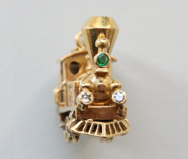 Vintage Van Cleef and Arpels 18ct Gold Locomotive Train Charm; with diamond and emerald set headlights, Signed and numbered 97265, with Van Cleef & Arpels 18ct gold chain bracelet.