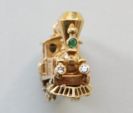 Vintage Van Cleef and Arpels 18ct Gold Locomotive Train Charm; with diamond and emerald set headlights, Signed and numbered 97265, with Van Cleef & Arpels 18ct gold chain bracelet.