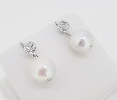 South Sea Pearl and Diamond Drop Earrings; featuring South Sea pearls suspended from a diamond set cluster stud, 0.28 carats, 18ct white gold